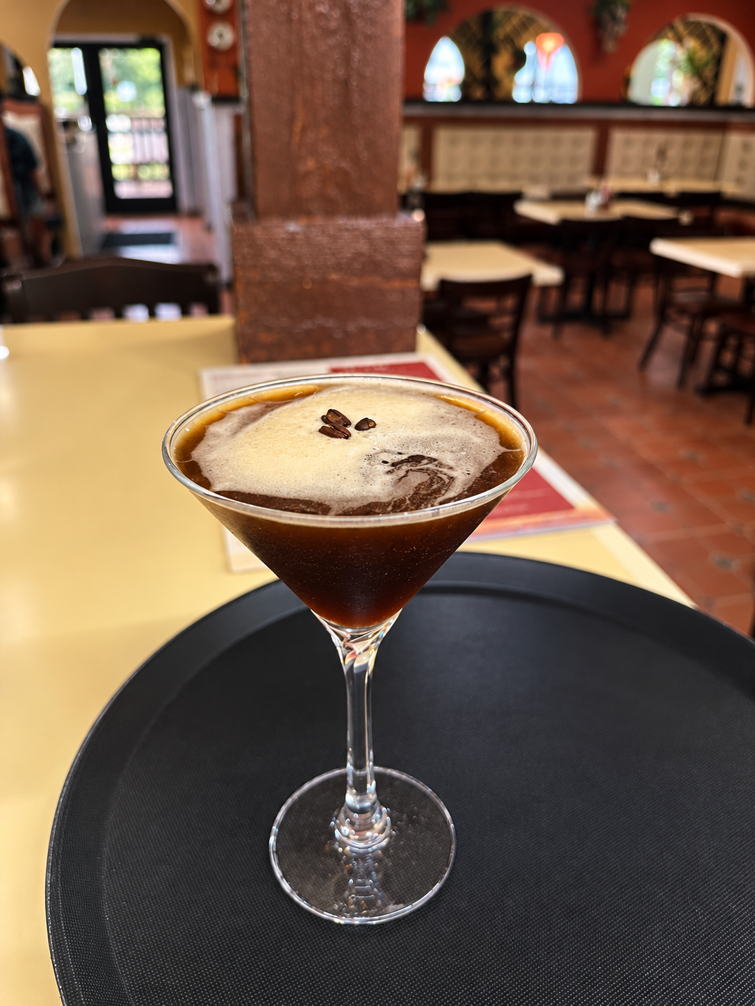 Espresso martini with a velvety cream float and coffee beans