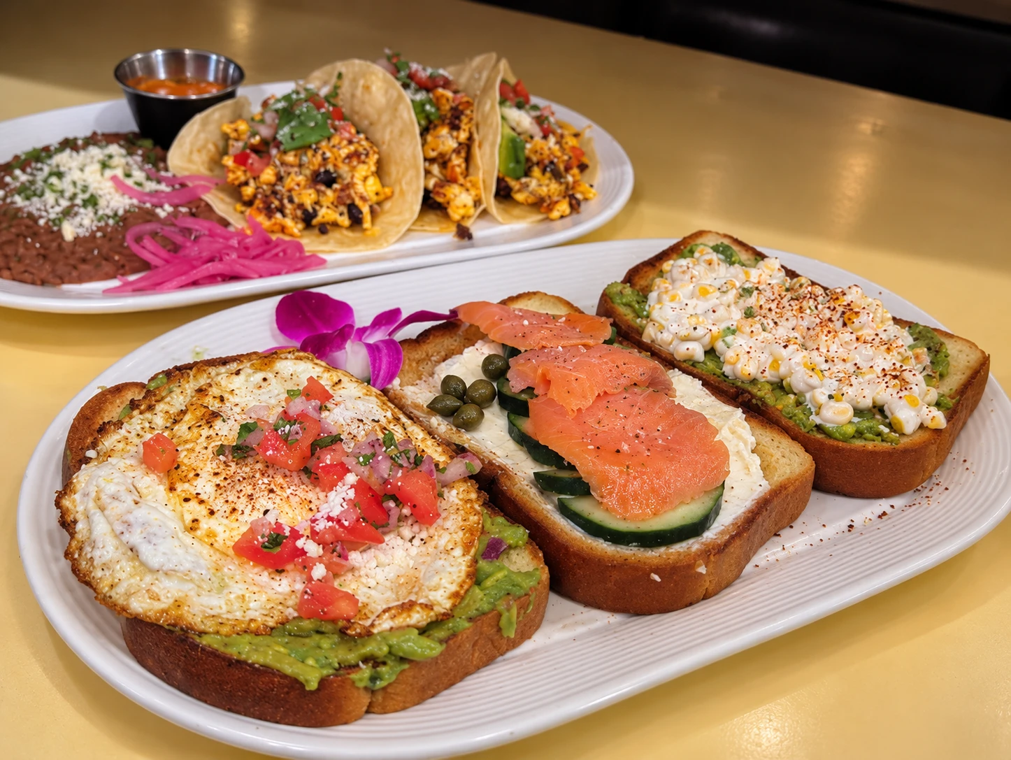 Egg, smoked salmon and corn breakfast toasts with breakfast tacos in the background